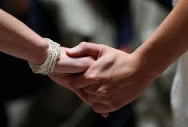 women_holding_hands